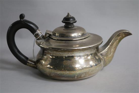 A 1920s small silver teapot, of squat circular form, gross 14.5 oz.
